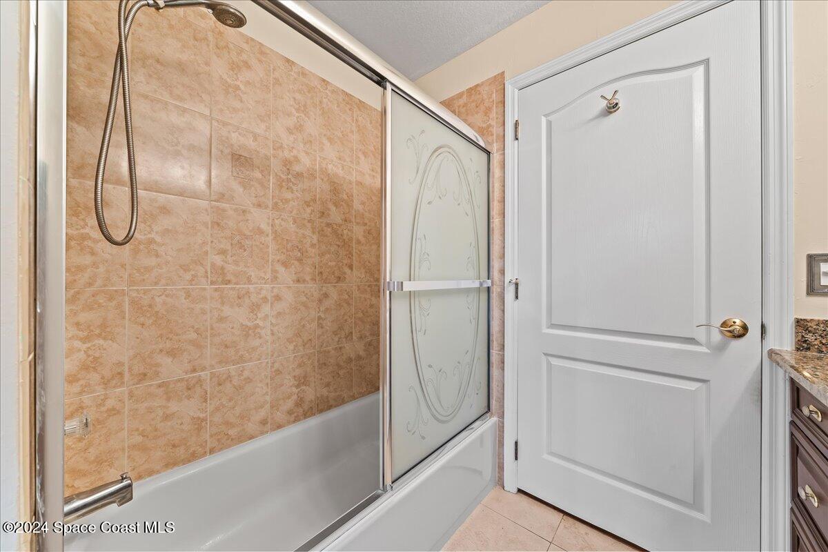 4360 Canard Road Melbourne, FL 32934 - Photo 30 of 54 a bathroom with a glass shower door