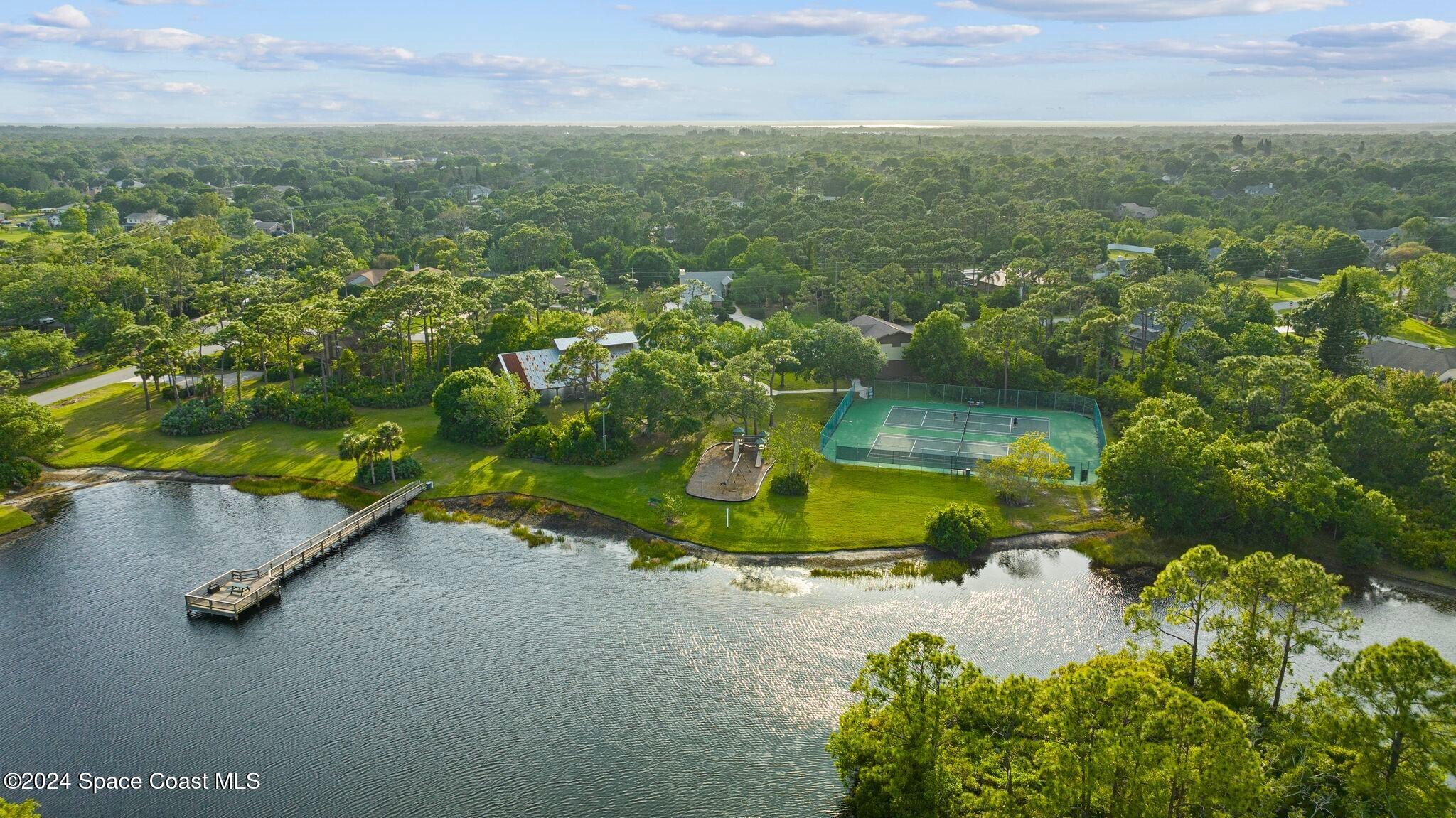 4360 Canard Road Melbourne, FL 32934 - Photo 47 of 54 an aerial view of a house with a yard and lake view