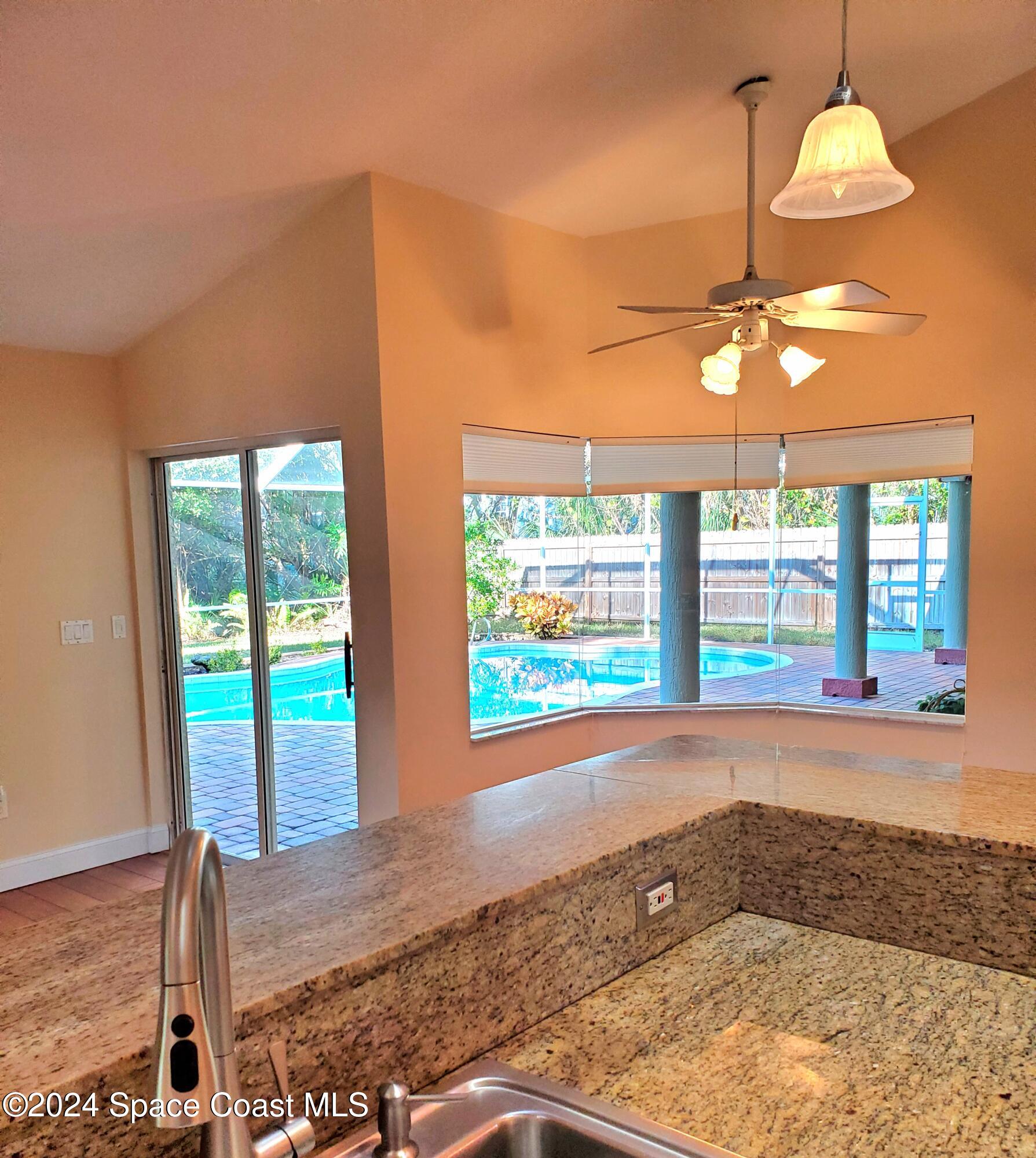 4360 Canard Road Melbourne, FL 32934 - Photo 8 of 54 a view of empty room with wooden floor and fan
