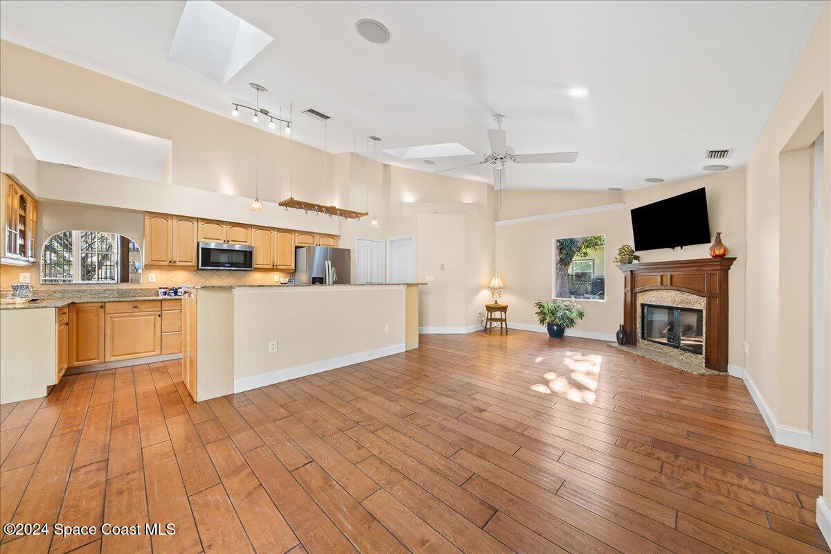 4360 Canard Road Melbourne, FL 32934 - Photo 9 of 54 a large white kitchen with cabinets and wooden floor