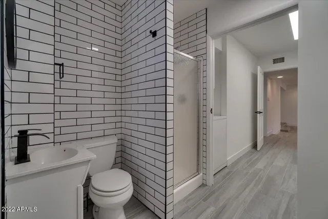 a bathroom with a toilet and a shower
