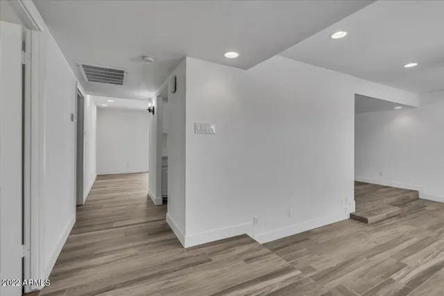 a view of a hallway with wooden floor