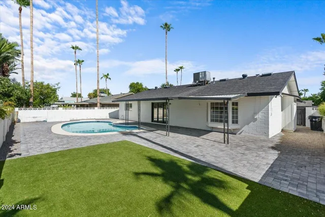 a view of a house with a bath tub and wooden fence