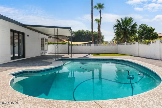 a view of a swimming pool with a patio