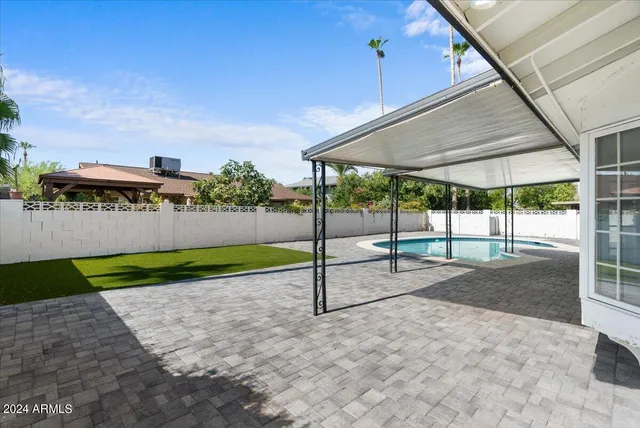 a view of a swimming pool with a lounge chairs