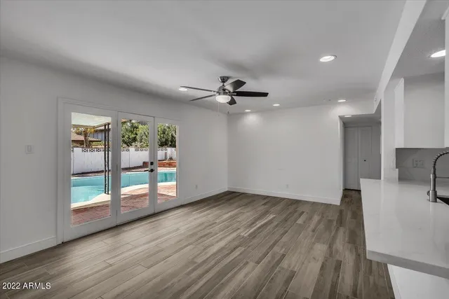wooden floor in an empty room with a window