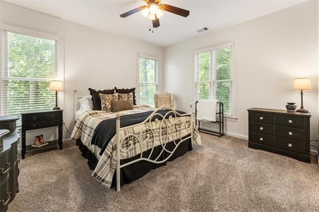 3910 Two Rivers Drive Cumming, GA 30041 - Photo 52 of 110 a bed room with a bed and a chandelier