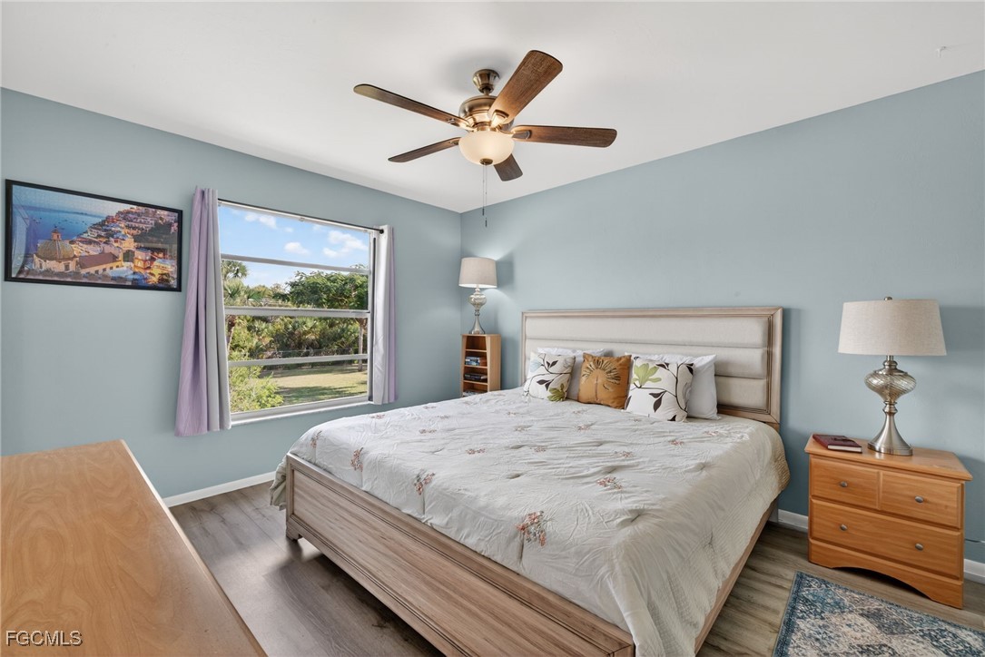 1100 Pondella Road, Unit 811 Cape Coral, FL 33909 - Photo 12 of 24 a bedroom with a large bed and a window