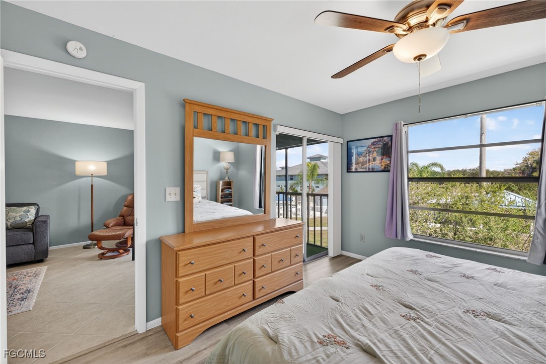 1100 Pondella Road, Unit 811 Cape Coral, FL 33909 - Photo 13 of 24 a bedroom with a bed and a large window
