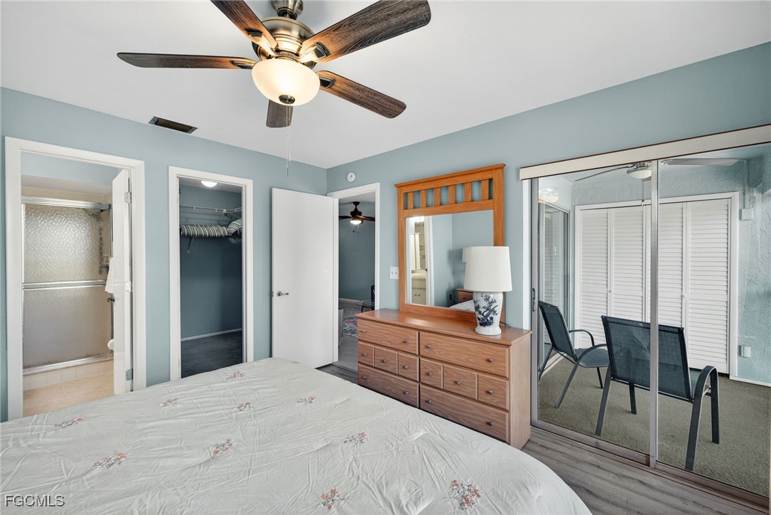 1100 Pondella Road, Unit 811 Cape Coral, FL 33909 - Photo 14 of 24 a bedroom with a bed and a chandelier