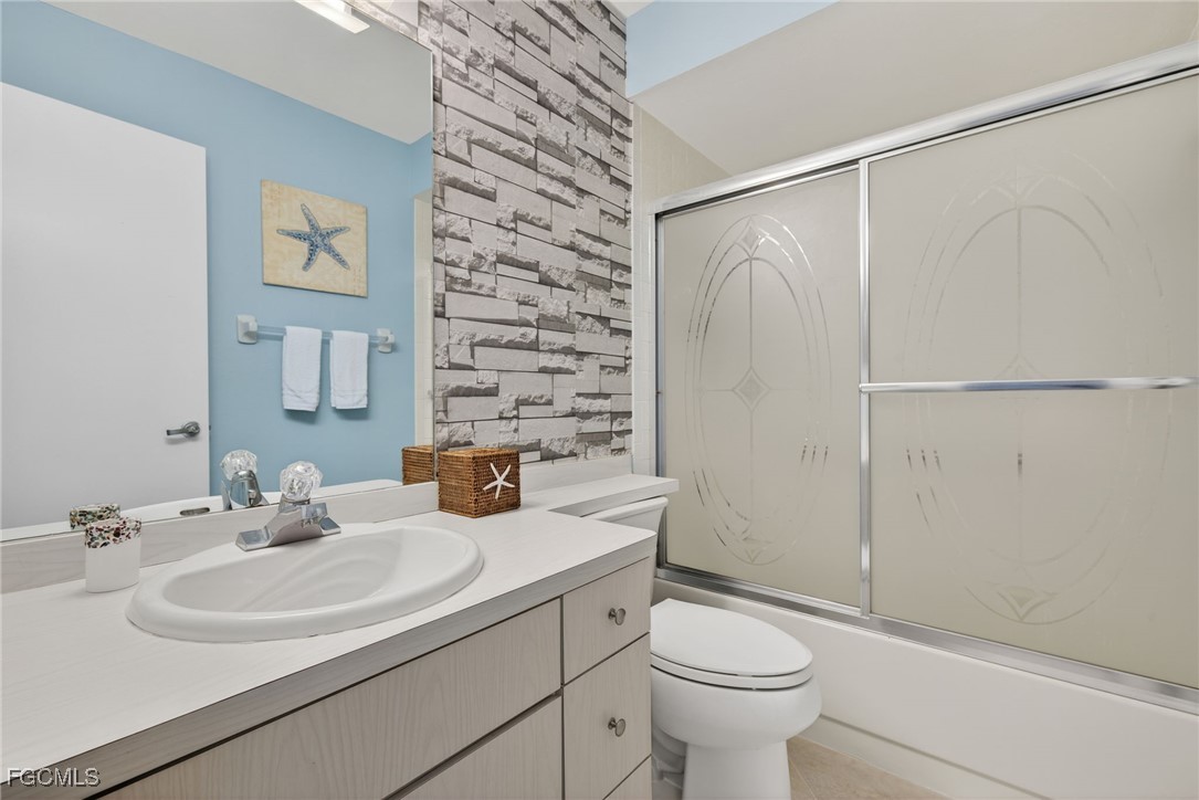 1100 Pondella Road, Unit 811 Cape Coral, FL 33909 - Photo 17 of 24 a bathroom with a sink toilet and shower