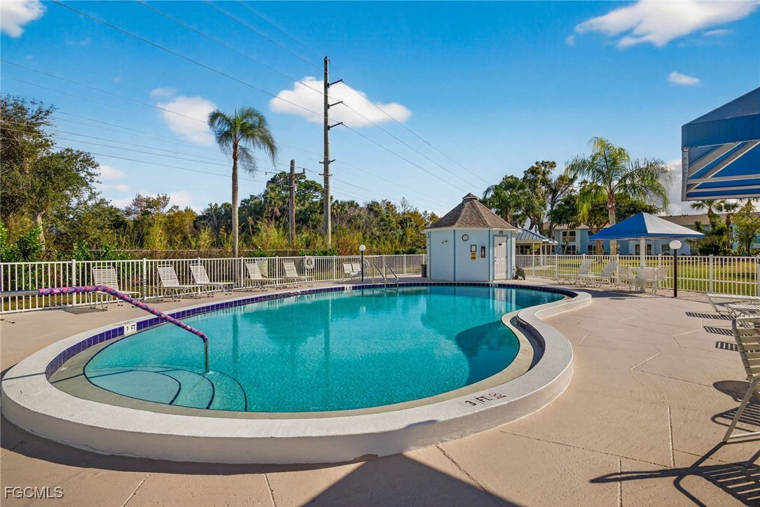 1100 Pondella Road, Unit 811 Cape Coral, FL 33909 - Photo 21 of 24 a view of a swimming pool with a house