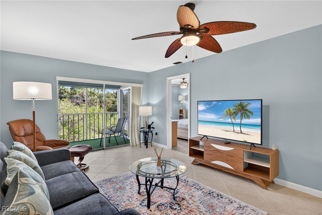 1100 Pondella Road, Unit 811 Cape Coral, FL 33909 - Photo 8 of 24 a living room with furniture a ceiling fan and a large window