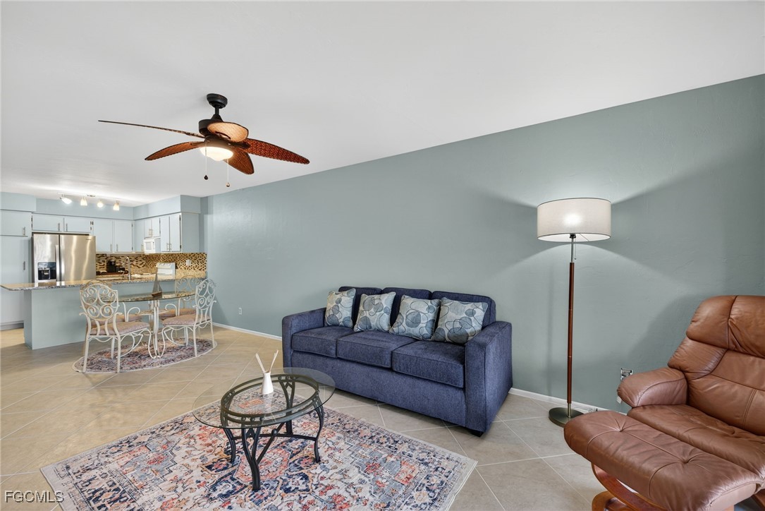 1100 Pondella Road, Unit 811 Cape Coral, FL 33909 - Photo 9 of 24 a living room with furniture and a chandelier