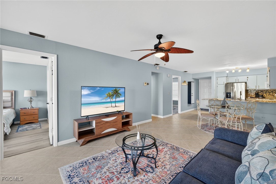 1100 Pondella Road, Unit 811 Cape Coral, FL 33909 - Photo 10 of 24 a living room with furniture and kitchen view