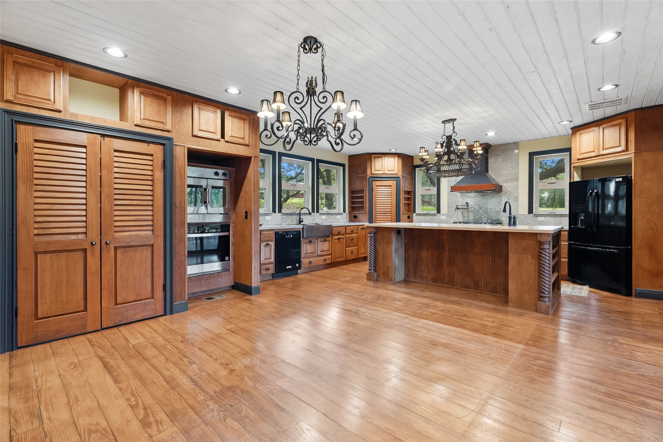 4032 Ranch Road 3232 Johnson City, TX 78636 - Photo 5 of 40 Gorgeous kitchen features large island, copper sinks, ample storage and direct access to large covered patio
