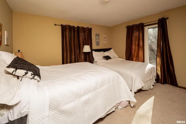 a bedroom with a bed and a large mirror