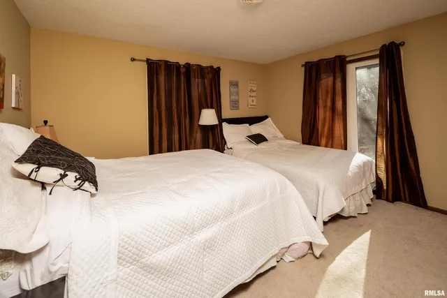 a bedroom with a bed and a large mirror