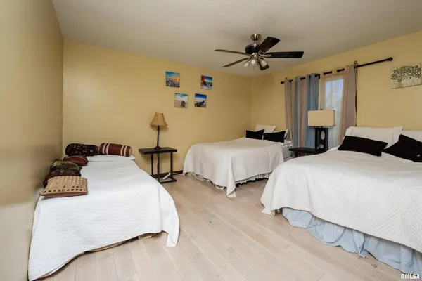 a bedroom with two beds and a chandelier