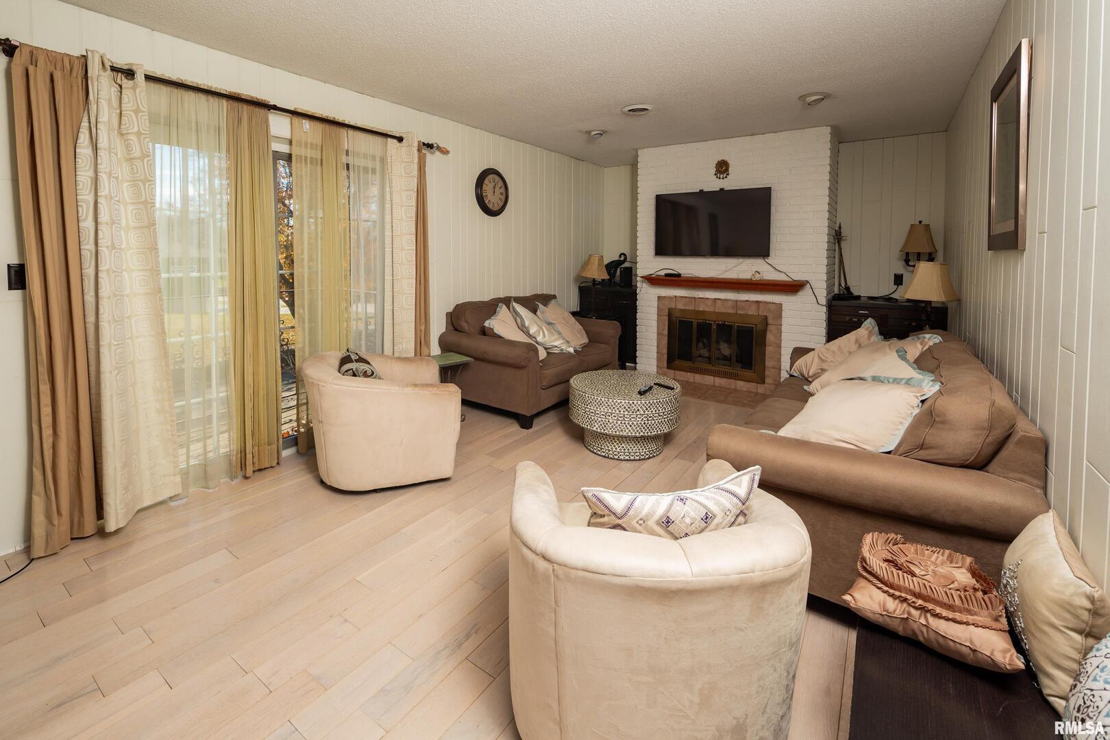 3623 34th Street Moline, IL 61265 - Photo 3 of 17 a living room with furniture a fireplace and a flat screen tv