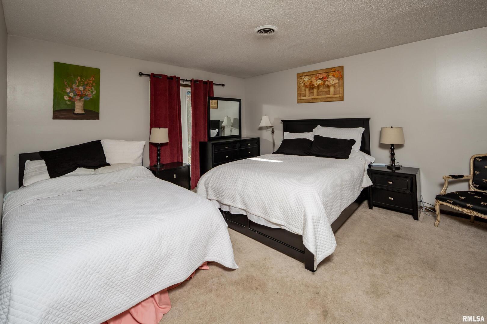 3623 34th Street Moline, IL 61265 - Photo 9 of 17 a bedroom with two beds and painting on the wall