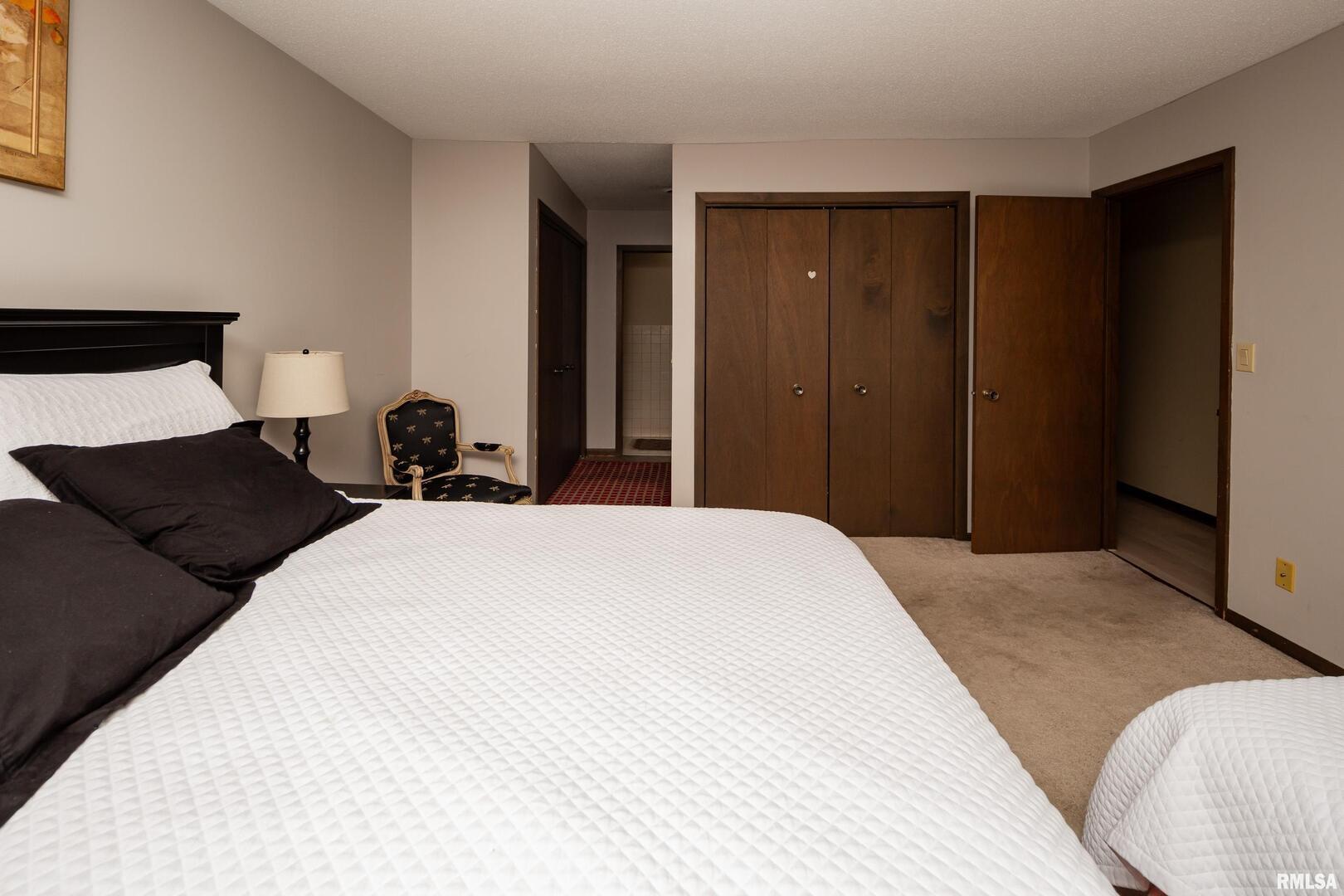 3623 34th Street Moline, IL 61265 - Photo 10 of 17 a bedroom with a bed and a large mirror