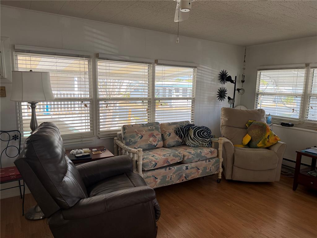 1040 Main Street, Unit 91 Dunedin, FL 34698 - Photo 12 of 25 a living room with furniture and a large window
