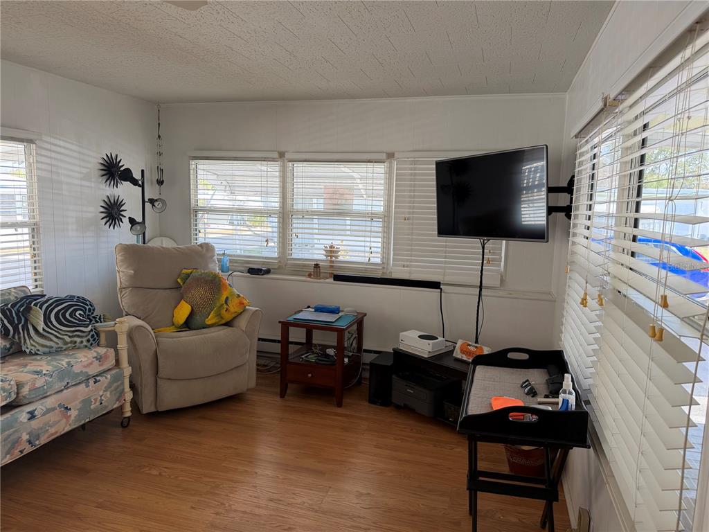 1040 Main Street, Unit 91 Dunedin, FL 34698 - Photo 13 of 25 a living room with furniture and a flat screen tv