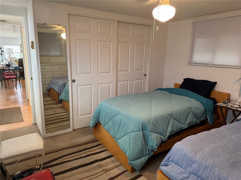 1040 Main Street, Unit 91 Dunedin, FL 34698 - Photo 23 of 25 a bedroom with a bed and cabinets