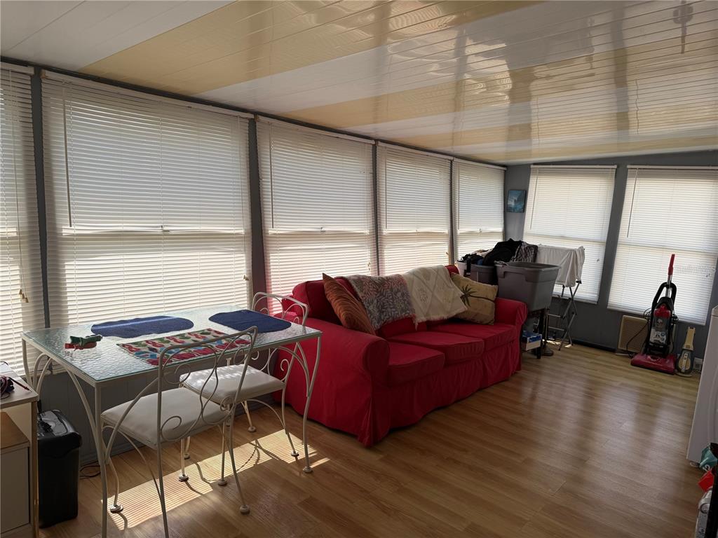 1040 Main Street, Unit 91 Dunedin, FL 34698 - Photo 4 of 25 a living room with furniture and a large window