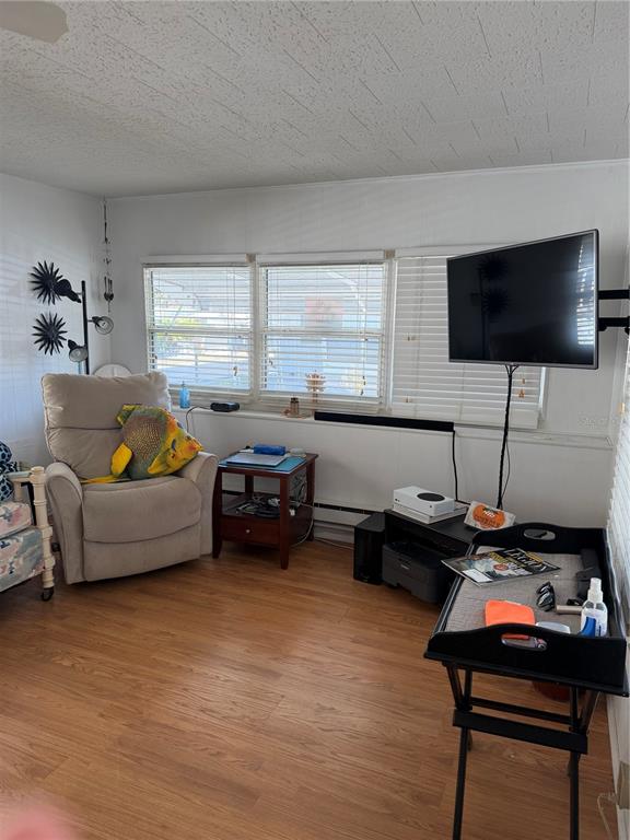 1040 Main Street, Unit 91 Dunedin, FL 34698 - Photo 5 of 25 a living room with furniture and a flat screen tv