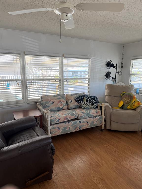 1040 Main Street, Unit 91 Dunedin, FL 34698 - Photo 6 of 25 a living room with furniture and a large window