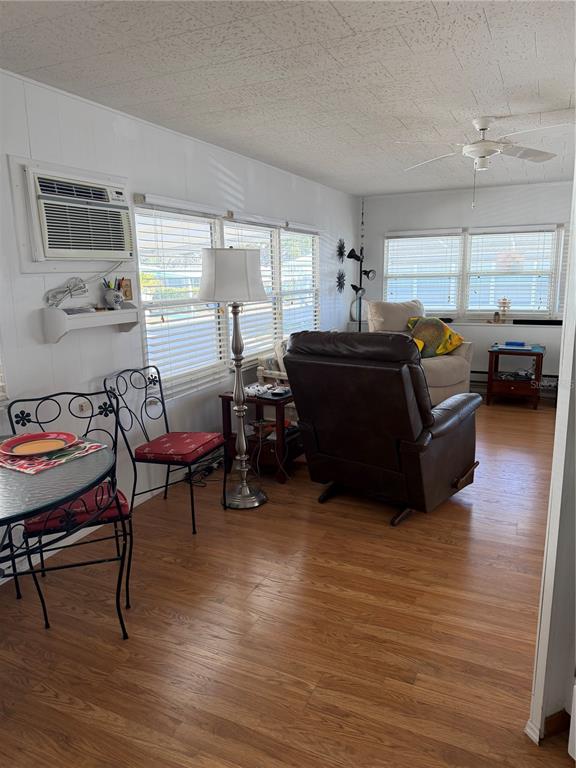 1040 Main Street, Unit 91 Dunedin, FL 34698 - Photo 10 of 25 a living room with furniture and a wooden floor