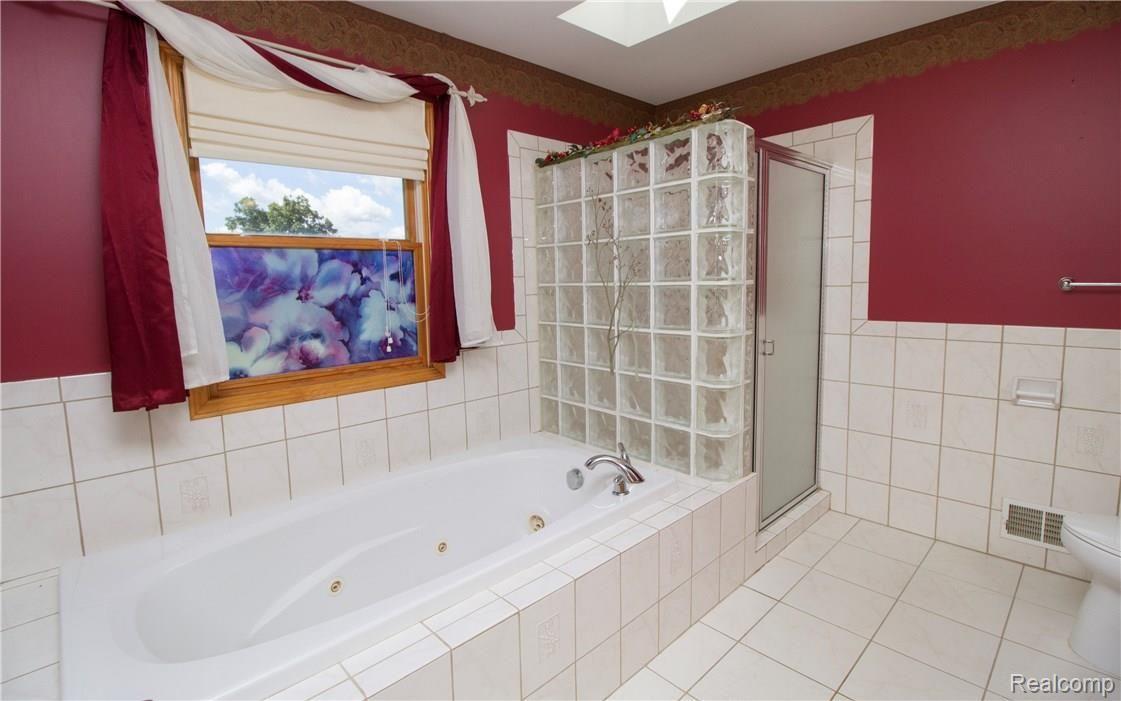 2447 Hadley Road Lapeer, MI 48446 - Photo 26 of 57 First floor Master bath with jetted tub and tiled shower