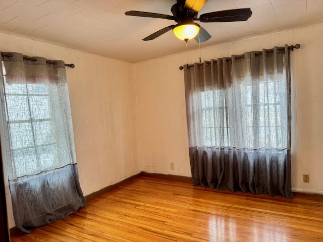 2918 Pershing Boulevard Clinton, IA 52732 - Photo 11 of 33 wooden floor in an empty room with a window