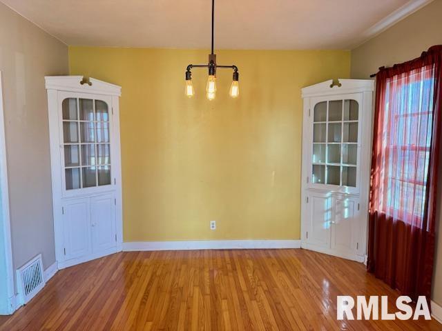2918 Pershing Boulevard Clinton, IA 52732 - Photo 6 of 33 a view of a room with wooden floor and cabinet