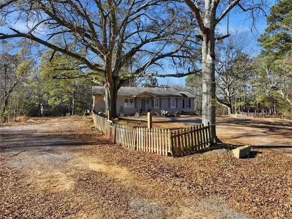 a view of a yard with a house and a tree