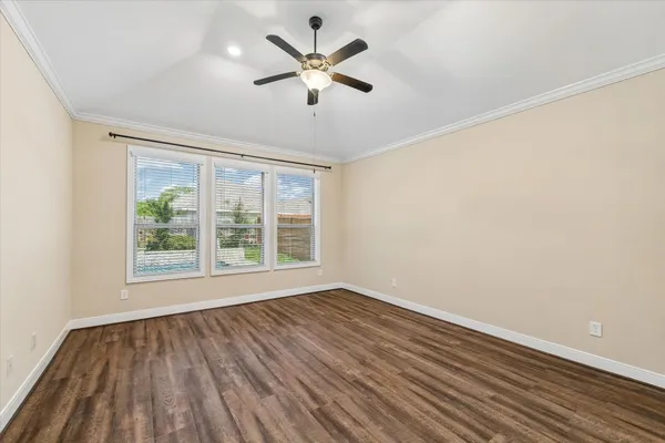 a view of room with hardwood floor and ceiling fan