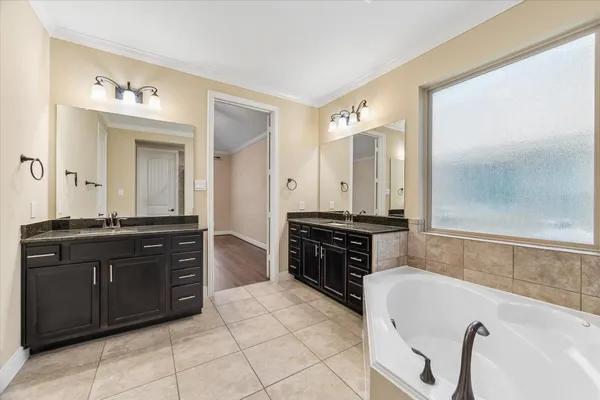 a bathroom with a tub and a sink