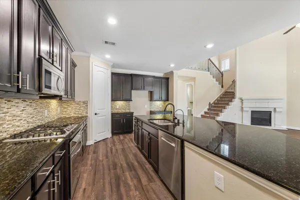 a kitchen with granite countertop lots of counter top space and stainless steel appliances