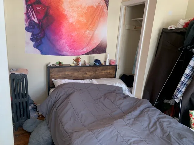 a bed sitting in a bedroom next to a window