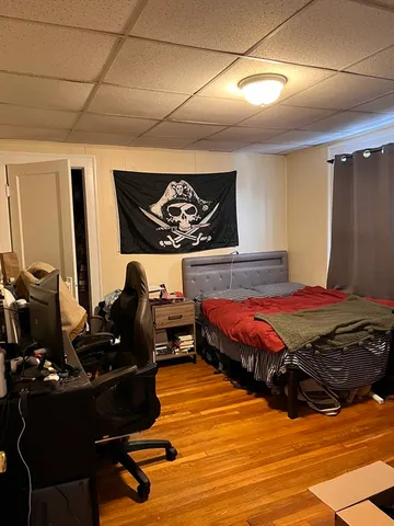 a bedroom with furniture and wooden floor