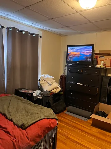a bedroom with a bed and a flat tv screen