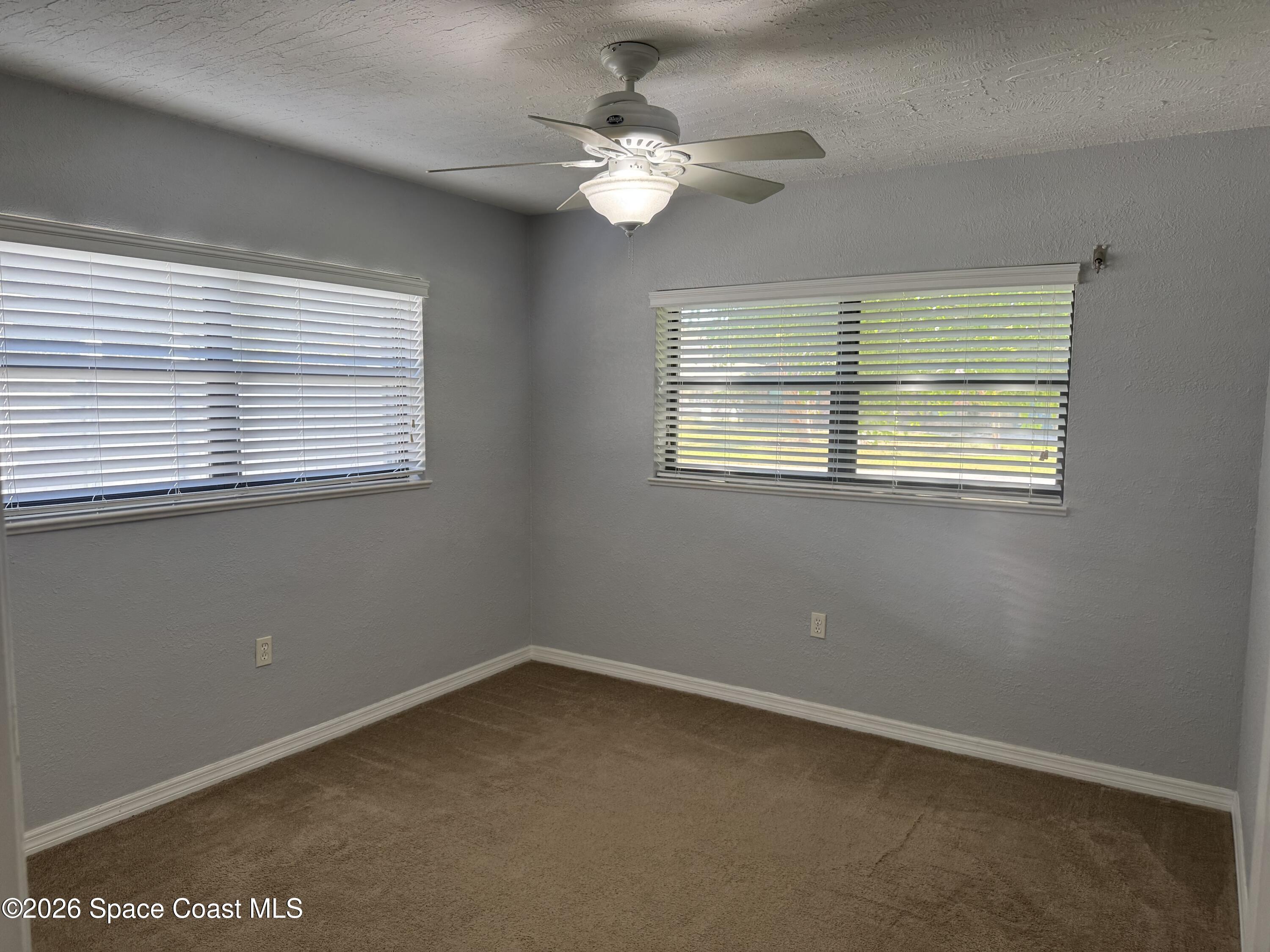 2135 South River Road Melbourne Beach, FL 32951 - Photo 9 of 14 a view of an empty room with a window