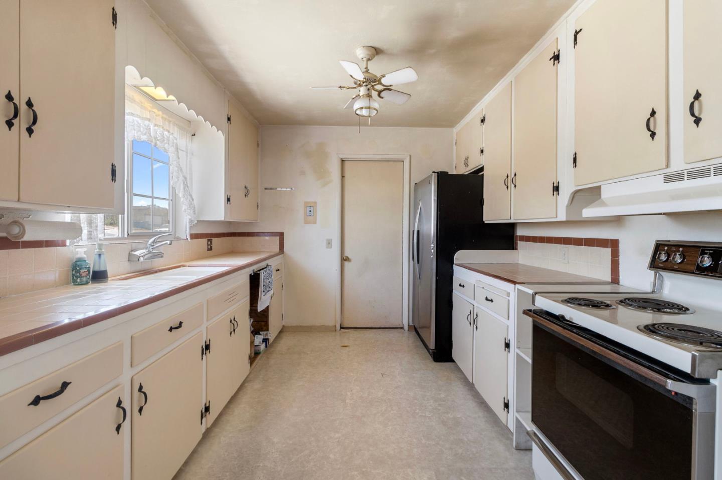 1949 Lincoln Street Seaside, CA 93955 - Photo 11 of 40 a kitchen with granite countertop a sink stove and refrigerator