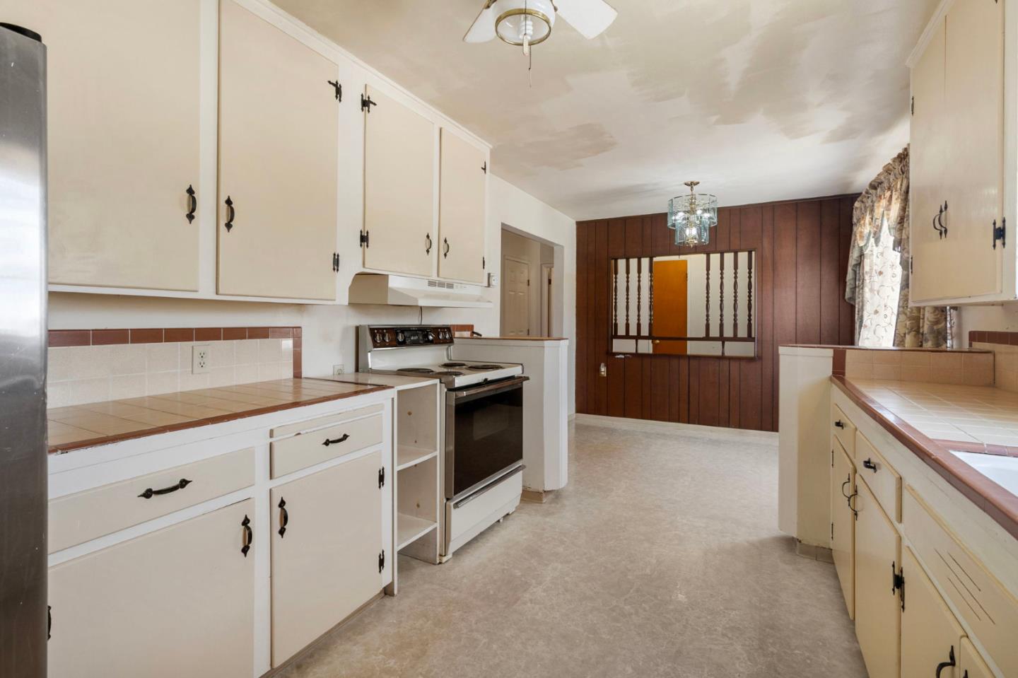 1949 Lincoln Street Seaside, CA 93955 - Photo 13 of 40 a kitchen with granite countertop white cabinets and white appliances