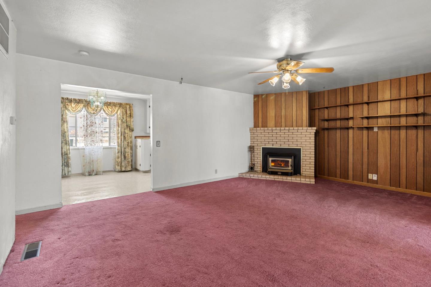 1949 Lincoln Street Seaside, CA 93955 - Photo 15 of 40 an empty room with windows fireplace and a kitchen view