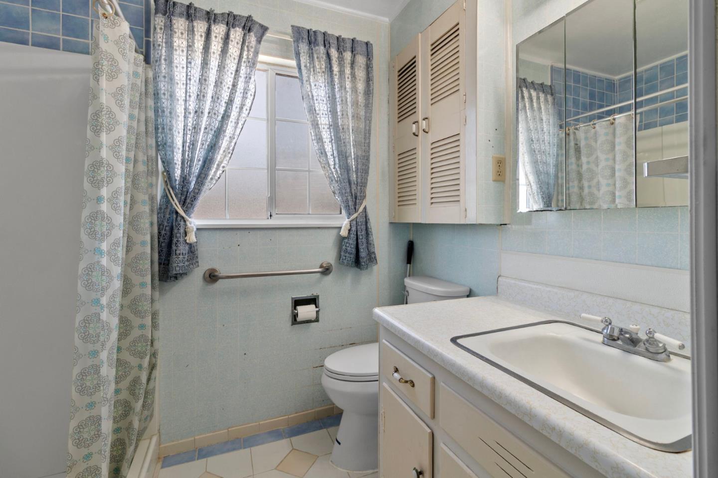 1949 Lincoln Street Seaside, CA 93955 - Photo 17 of 40 a bathroom with a sink a toilet and a shower