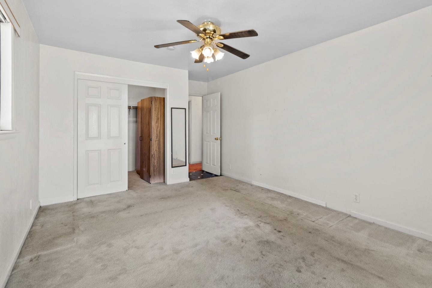 1949 Lincoln Street Seaside, CA 93955 - Photo 22 of 40 an empty room with closet and a chandelier fan
