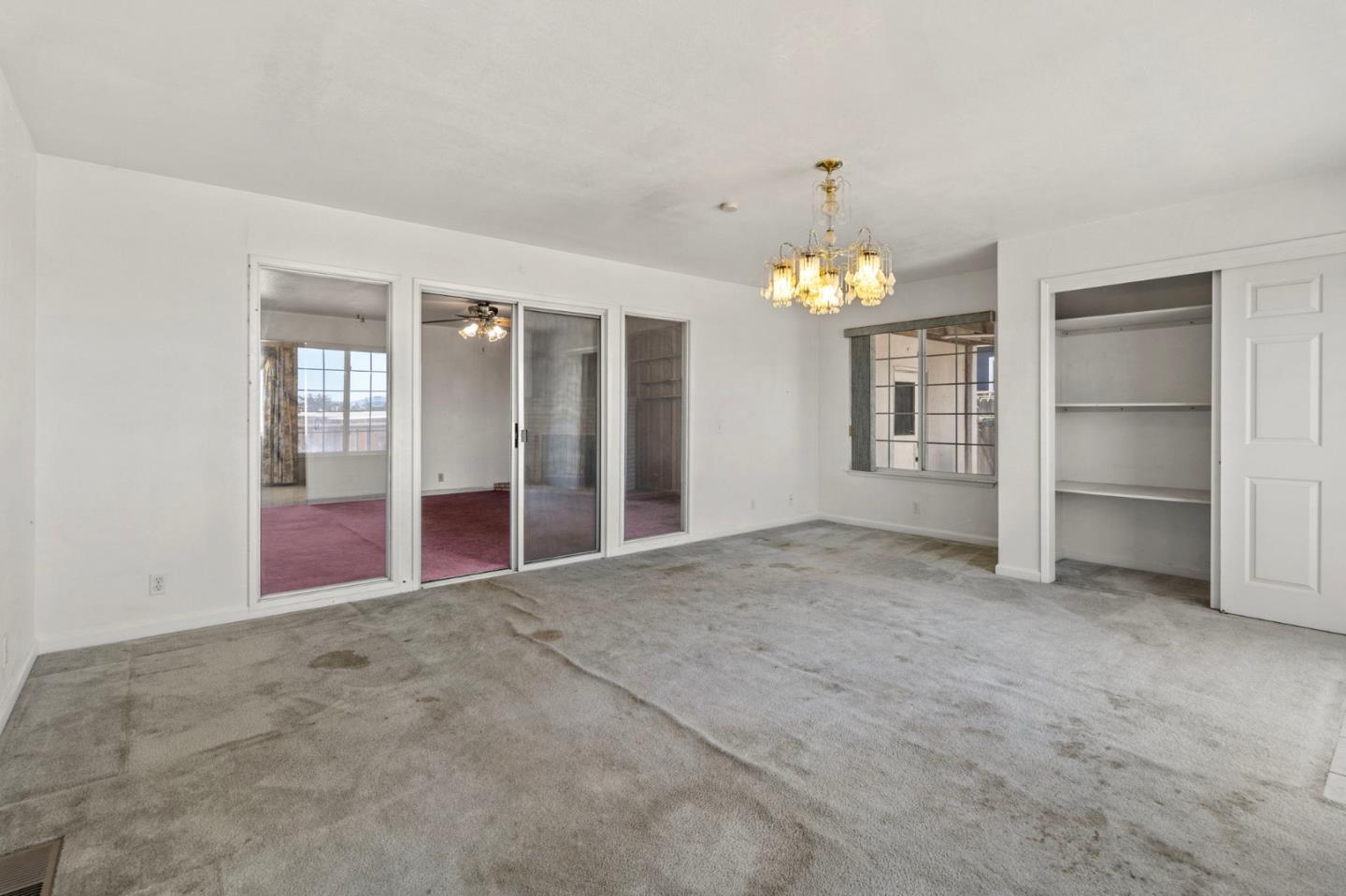 1949 Lincoln Street Seaside, CA 93955 - Photo 26 of 40 an empty room with chandelier and windows
